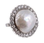 A mabe pearl and diamond ring,   circa 1920,    the mabe pearl within a surround of brilliant cut