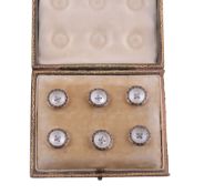 A set of six buttons  , circa 1910, the buttons each centred with a circular mother of pearl panel