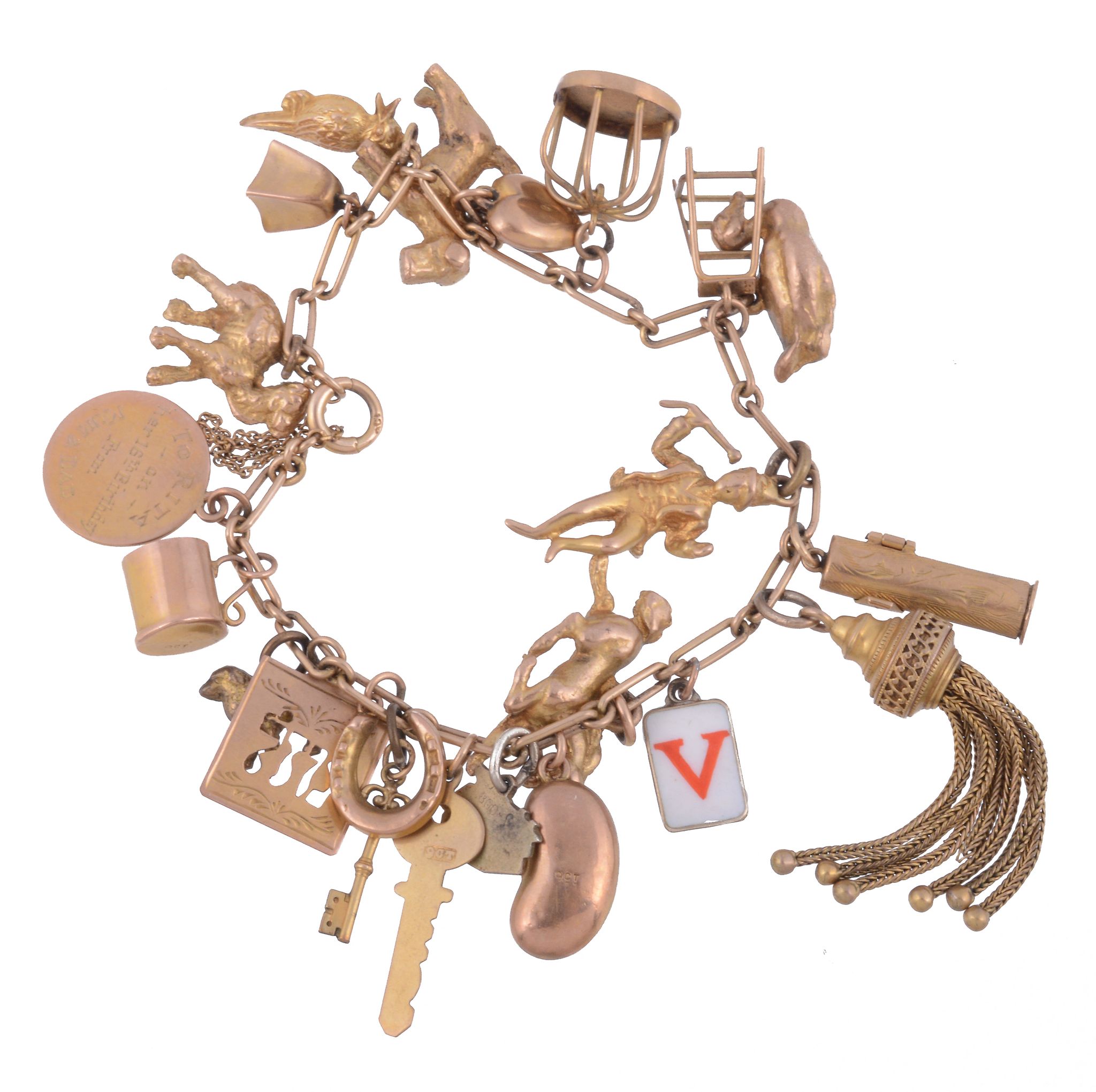 A gold coloured charm bracelet,   the fancy belcher links suspending various charms, including