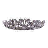 A white paste set tiara,   circa 1950, the white metal sunburst panels set with circular shaped