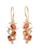 A pair of citrine and diamond earrings,   the oval shaped citrines with diamond accented curved