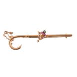 A gem set bar brooch,   circa 1900, the crook shaped bar with an applied foliate panel set with