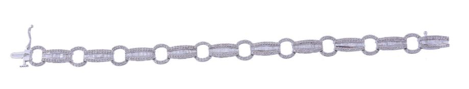 A diamond bracelet,   the bracelet with alternating tonneau shaped panels set with baguette and
