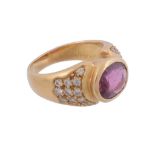 A ruby and diamond ring,   the oval shaped ruby in a collet setting, between brilliant cut diamond