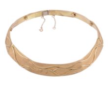 An 18 carat gold collar necklace  , the necklace composed of seven graduated textured panels with