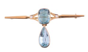An aquamarine brooch,   the cushion shaped aquamarine collet set on a polished bar, suspending a