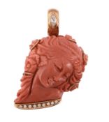 A coral pendant,   carved with the profile of a lady with flowers in her hair, the bale set with a