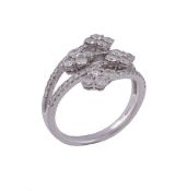 A diamond dress ring,   the four crossover diamond set bars each terminating with a quatrefoil of