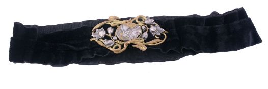 An Art Nouveau belt buckle designed by F Lasserre,   circa 1900, the silvered and gilt metal buckle