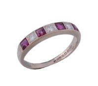 An 18 carat gold ruby and diamond ring,   set with alternating square shaped rubies and brilliant