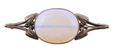 An opal set brooch  , the oval cabochon opal estimated to weigh 16.03 carats within a gilt metal