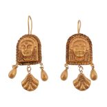 A pair of ancient style ear pendents  , each panel with a relief of a face with granulated