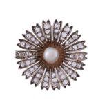 A diamond and pearl flower head brooch,   circa 1900, the flower head set with a central pearl