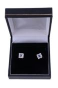 A pair of sapphire and diamond ear studs,   the central square shaped sapphire within a surround of