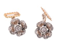 A pair of diamond flower head cufflinks  , the pierced two colour flower heads with a central
