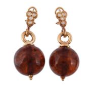 A pair of amber earrings,   the amber orbs suspended from a polished loop, set with brilliant cut