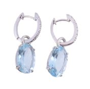 A pair of aquamarine and diamond earrings,   the oval shaped aquamarine in a four claw setting