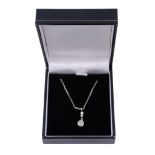 A diamond pendant,   the pear shaped old cut diamond in a pinched collet setting, on a fancy link