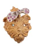 A novelty terrier brooch  , the textured long haired dog with a ruby set bow, stamped 750 with