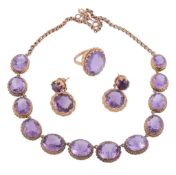 A suite of amethyst jewellery,   the necklace with graduated oval cut amethyst within beaded