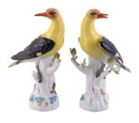 A pair of Meissen models of golden orioles, 20th century, blue crossed marks   A pair of Meissen