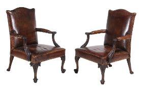 A pair of leather Gainsborough armchairs  , in George III style, early 20th century, each with