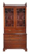 A George IV mahogany secretaire bookcase,   circa 1825, possibly American, the pierced and dentil