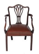 A George III mahogany elbow chair,   circa 1780, the carved curved top rail above pierced splat,