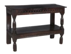 An o ak side table,   17th century and later, the rect angular top with carved edge above arcaded