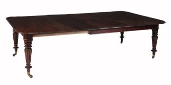 A William IV mahogany extending dining table on reeded legs  , circa 1835, the rectangular top with