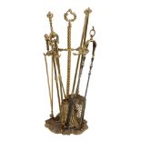 A matched set of George III brass and steel fire irons,   early 19th century, comprising shovel,