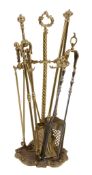 A matched set of George III brass and steel fire irons,   early 19th century, comprising shovel,