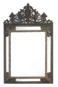 An embossed brass mounted wall mirror in 17th century Dutch style  , 19th century, the surmount