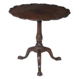 A George III mahogany tripod table  , the top with piecrust edge above a turned baluster stem and