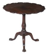 A George III mahogany tripod table  , the top with piecrust edge above a turned baluster stem and