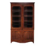 A Regency mahogany library bookcase  , circa 1815, the moulded cornice above a pair of brass