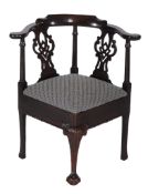 A mahogany corner armchair,   circa 1770 and later, the curved yoke back above turned pillars and