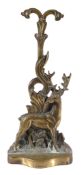 A Victorian brass and iron weighted door porter,   late 19th century, relief cast as a stag