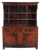 An oak high dresser  , second half 18th century, probably North Wales, the carved frieze above two