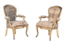 A pair of William IV carved giltwood armchairs  , circa 1835, each balloon shaped back carved with