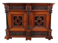 A Dutch carved oak and ebony cabinet,   19th century incorperating older carved elements, the