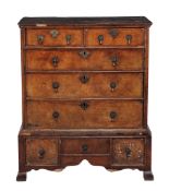 A George II walnut chest on stand  , circa 1740, the moulded cornice above two short and three long
