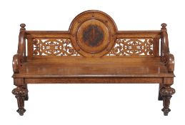A Victorian oak hall bench  , circa 1860, the raised back with central porthole containing stylised