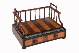 A William IV satinwood and rosewood book holder,   circa 1835, the three-quarter galleried top with