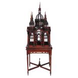 A mahogany birdcage,   20th century, of architectural form, the stand incorporating turned tapered