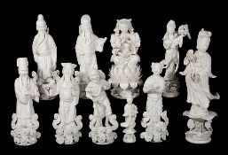A group of ten Dehua figutes  , 20th century, depicting Quanyin, immortals and others, 36cm high