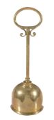A Victorian brass and lead weighted door porter,   last quarter 19th century, with loop handle