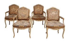 A set of four French cream painted and parcel gilt armchairs in Louis XV style  , early 20th