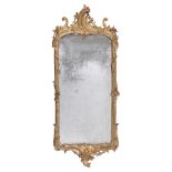 A Continental carved giltwood wall mirror  , circa 1760, the orginal plate within scrolled and