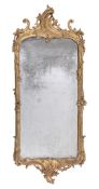 A Continental carved giltwood wall mirror  , circa 1760, the orginal plate within scrolled and